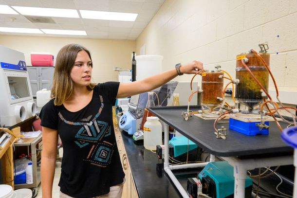 Carley Shingleton, a graduate research assistant at WVU's Benjamin M. Statler College of Engineering and Mineral Resources, assists in research to improve wastewater filtration in lagoon-based plants at the Mineral Resources Building. (WVU Photo/Matt Sund