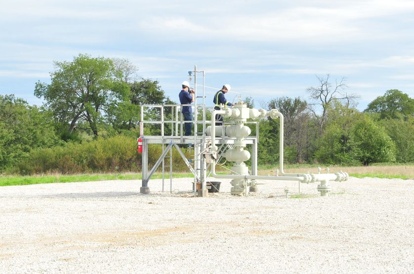 WVU researchers examine natural gas well equipment for potential methane emissions. (WVU Photo/Nigel Clark)