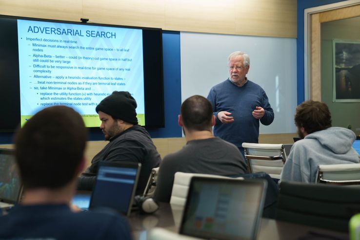 A photo of Research Associate Don McLaughlin lecturing to a computer science class.