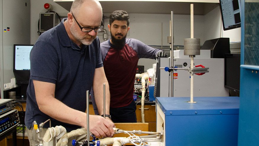 WVU Professor Ed Sabolsky works with materials science doctoral candidate Saad Waseem to prepare a SOEC test.