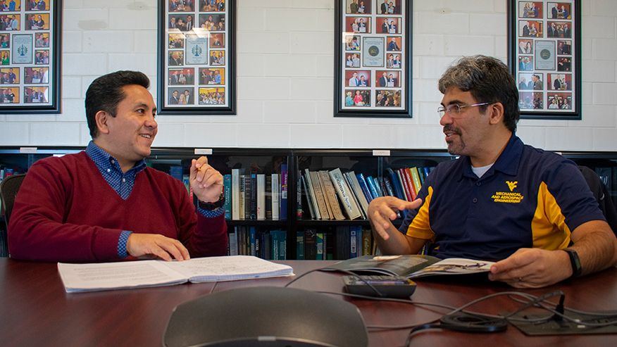 Eduardo Sosa and Guilherme Pereira collaborating in a conference room. 