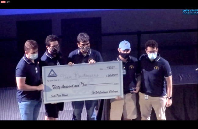 Members of Team Mountaineers holding a check