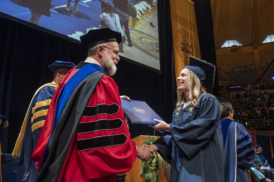 Mekenzie DeFranco receives her degree in animal and nutrition sciences from Davis College of Agriculture, Natural Resources and Design Dean Ken Blemings during December Commencement at the Coliseum Dec. 21, 2019.