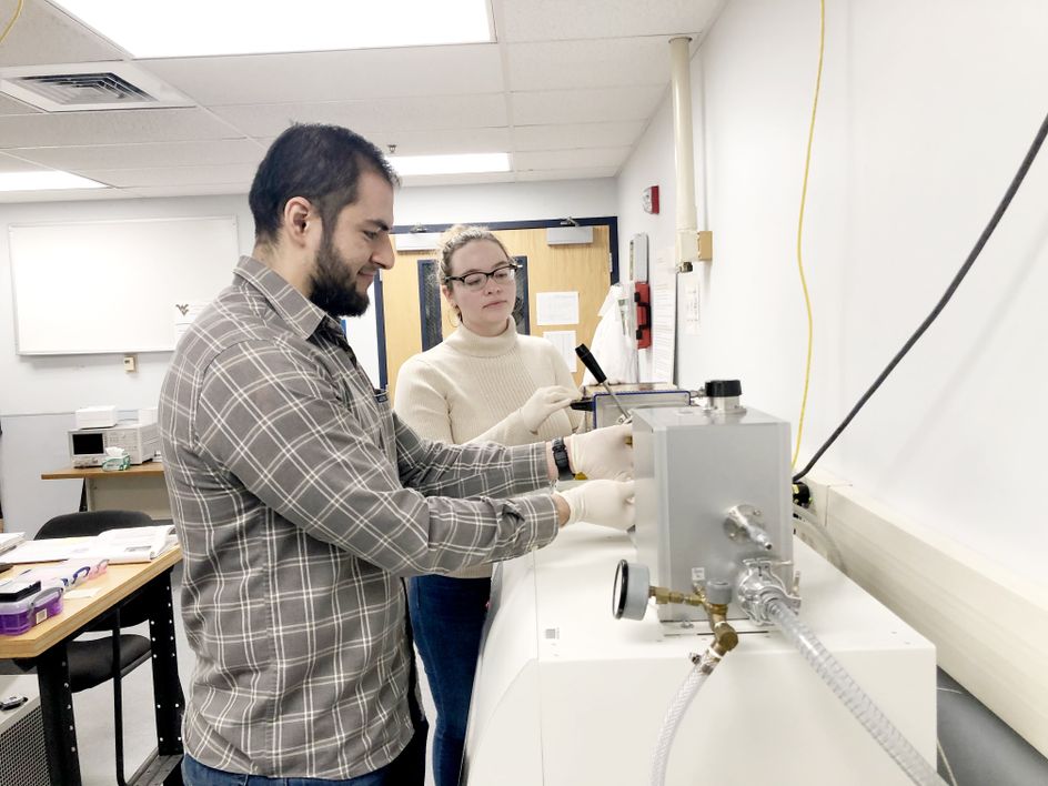 Graduate students in Song’s research lab perform a measurement of electrical properties. (Submitted photo)
