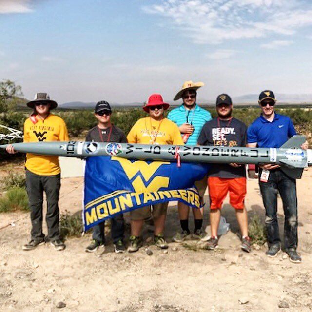 A photo of the WVU Rocketry Team holding the rocket.