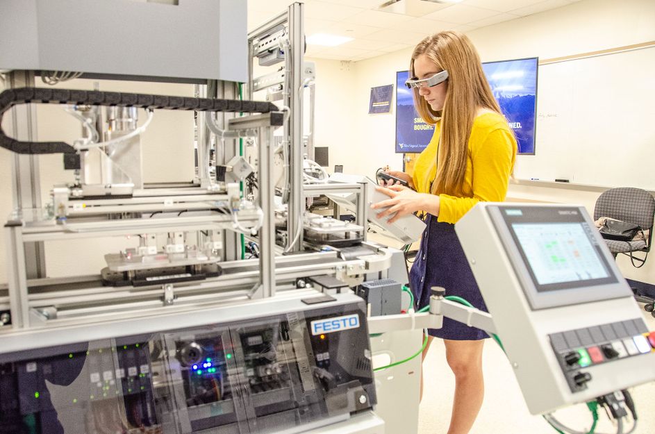 Female working at an advanced manufacturing system with virtual glasses.