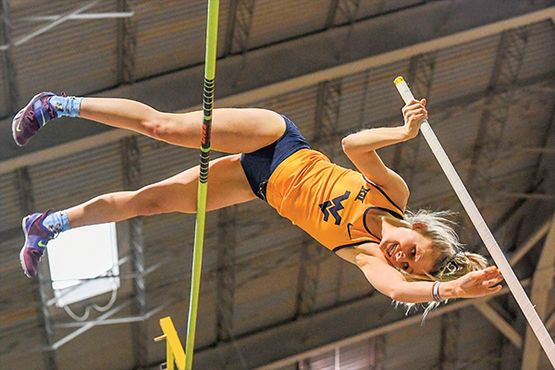 Ellie Gardner going over the bar during a pole vault competition.