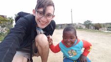 Jack Prommel with a small boy while volunteering in Capetown, South Africa 