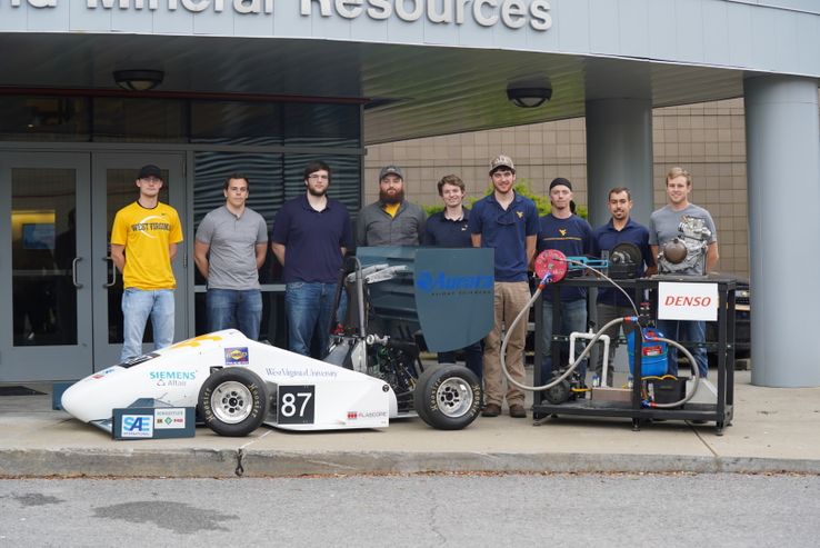 WVU student race team standing alongside the 2018 Mountaineer Racing Formula SAE® Race Car
