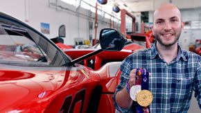 Nicco Campriani beside the Ferrari F1 Racer, showing off his metals