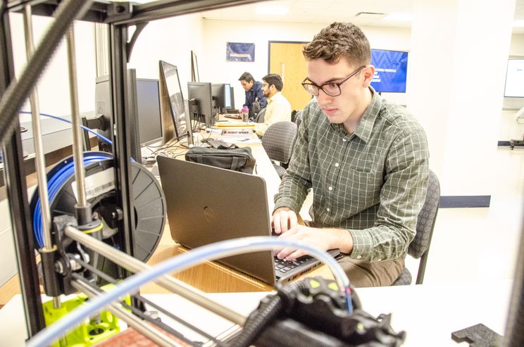 IMSE student, Joseph Sullivan, working in the Smart Manufacturing Research Lab