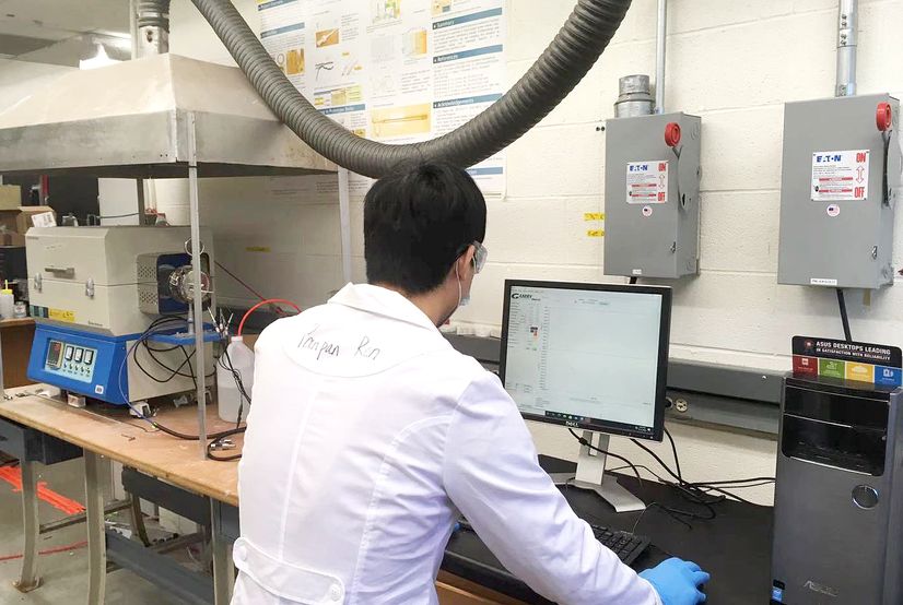 Shanshan Hu, a postdoctoral scholar, performs a high temperature corrosion measurement of alloys