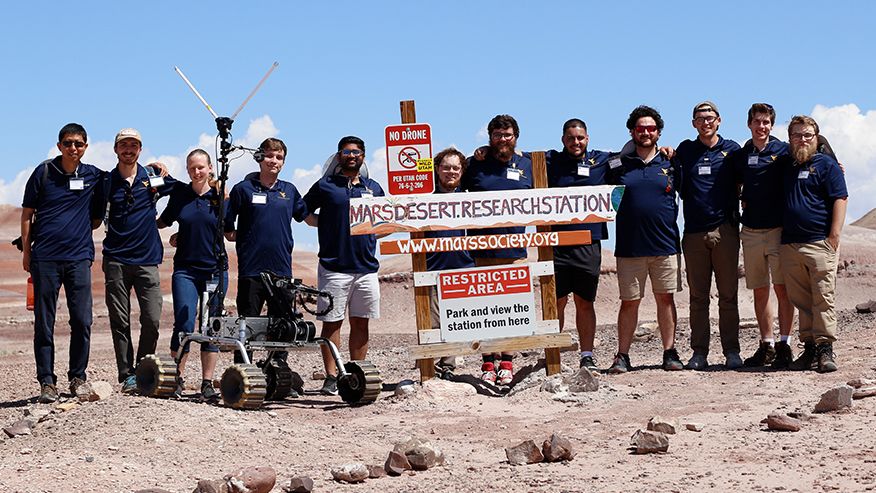 Members of Team Mountaineers, the winners of the 2023 University Rover Challenge, celebrate in Utah. They are (left to right) Yu Gu, faculty adviser, Spencer Regnier, Kendra Gillo, Zachary Waddell, Shubh Patel, Michael Lemon, Eamonn Payton, Malik Mukdadi, Riley McAllister, Stephen Jacobs, Daniel McDonald and Robert Cook with the WVU Benjamin M. Statler College of Engineering and Mineral Resources. 