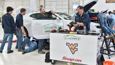 Team members work on the Chevrolet hybrid Camaro.