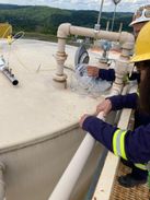 students study methane leaks by taking a sample of vent emissions from a shale gas liquid storage tank