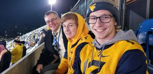 Billy with his father and brother at a WVU football game.