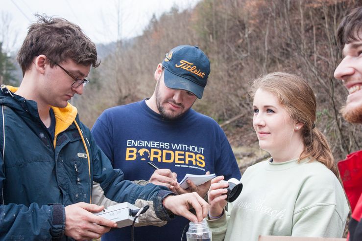 A photo of three Engineers Without Borders members in Prenter.