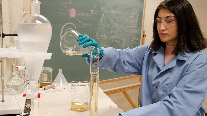 A graduate student working on tests to extract critical and rare earth minerals. 