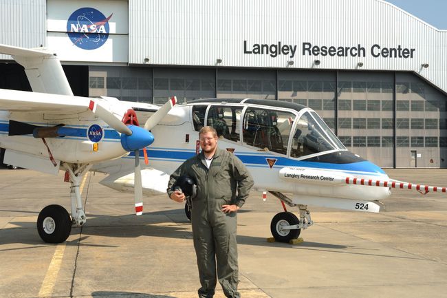 Matt Underwood stands in front of an airplane at Langley Research Center
