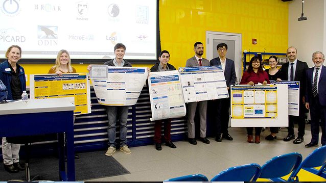 Graduate poster winners holding their posters