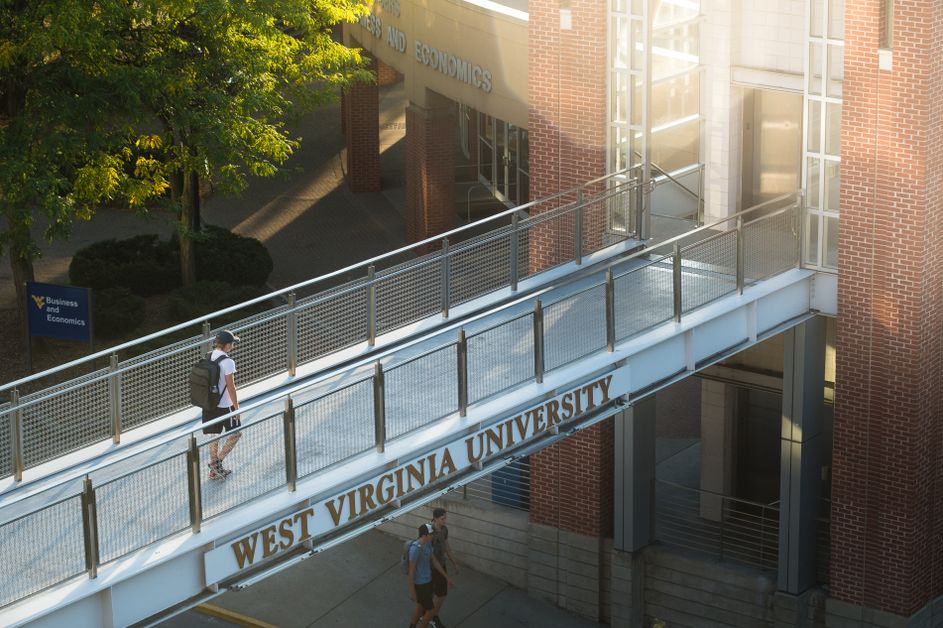 Student walks across the B&E footbridge after a day of class. 
