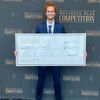 Robert Gianniny poses with his check at the Collegiate Business Plan Competition