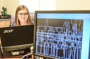 Female research student working with computer modeling