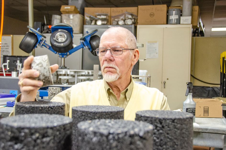 John Zaniewski reviewing asphalt samples in his lab.