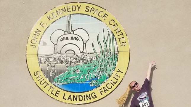 Kearney in front of the JFK Space Center sign