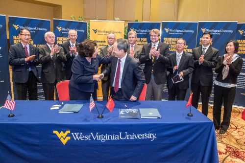 (WVU Photo by Brian Persinger) -- Provost Joyce McConnell shakes hands with Wang Shumin, senior vice president, Shenhua Energy Company, at a signing ceremony in Morgantown, West Virginia.