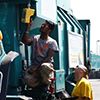 Arvind Thiruvengadam (left) and Saroj Pradhan (right) check for leaks in the natural gas fuel system of a refuse truck.