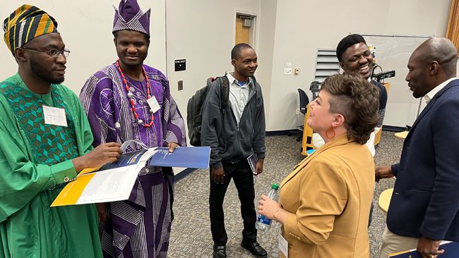 Alumni Bevin VanGilder and Olayemi Akinkugbe interact with students during All Voices as ONE: Together We Can Innovate and Shape the Future.