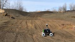 Pathfinder, a lightweight, small-scale test rover, roams an ash pile in Point Marion, Pennsylvania.