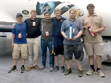 A photo of the rocketry team members with their award.