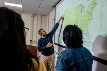 Omar Abdul-Aziz, a WVU Statler College researcher, points to a map while discussing his newly released model for diagnosing the health of freshwater streams in the United States. (WVU Photo/Matt Sunday)