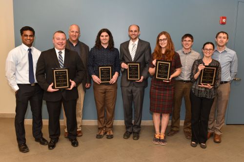 (WVU Photo by Jennifer Shephard) — 2016 Innovation Awards recipients from left: Arvind Thiruvengadam, Dan Carder, Greg Thompson, Michael Morehead, Brandon Lucke-Wold, Valeriya Gritsenko, Kevin Bandura, Maura McLaughlin, and Zachariah Etienne. Awards were presented Thursday, March 31, 2016 at the Reed College of Media's Media Innovation Center at Evansdale Crossing. 