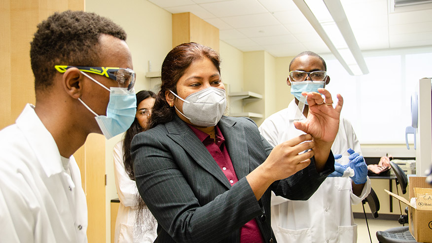 Biomedical engineering assistant professor, Soumya Srivastava works with her graduate students on microfluidic device fabrication in her lab. (WVU Photo/Paige Nesbit)