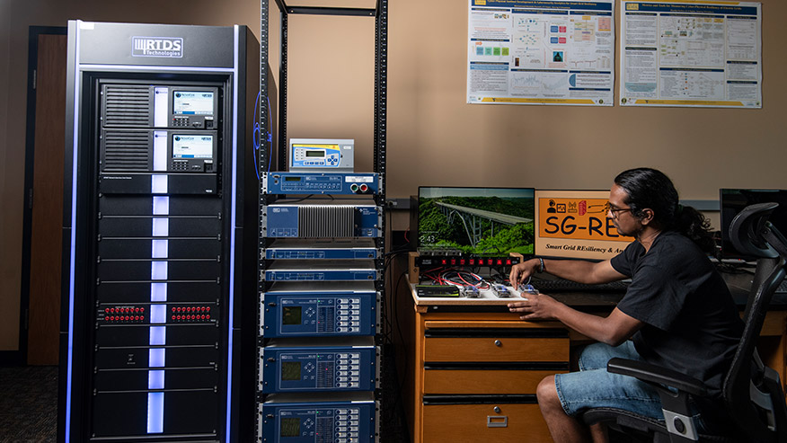 <p>Students in the Lane Department of Computer Science and Electrical Engineering conducting
  research on the smart grid. (WVU Photo/Brian Persinger)</p>