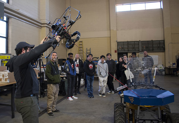 Students and faculty observe a robotics demonstration