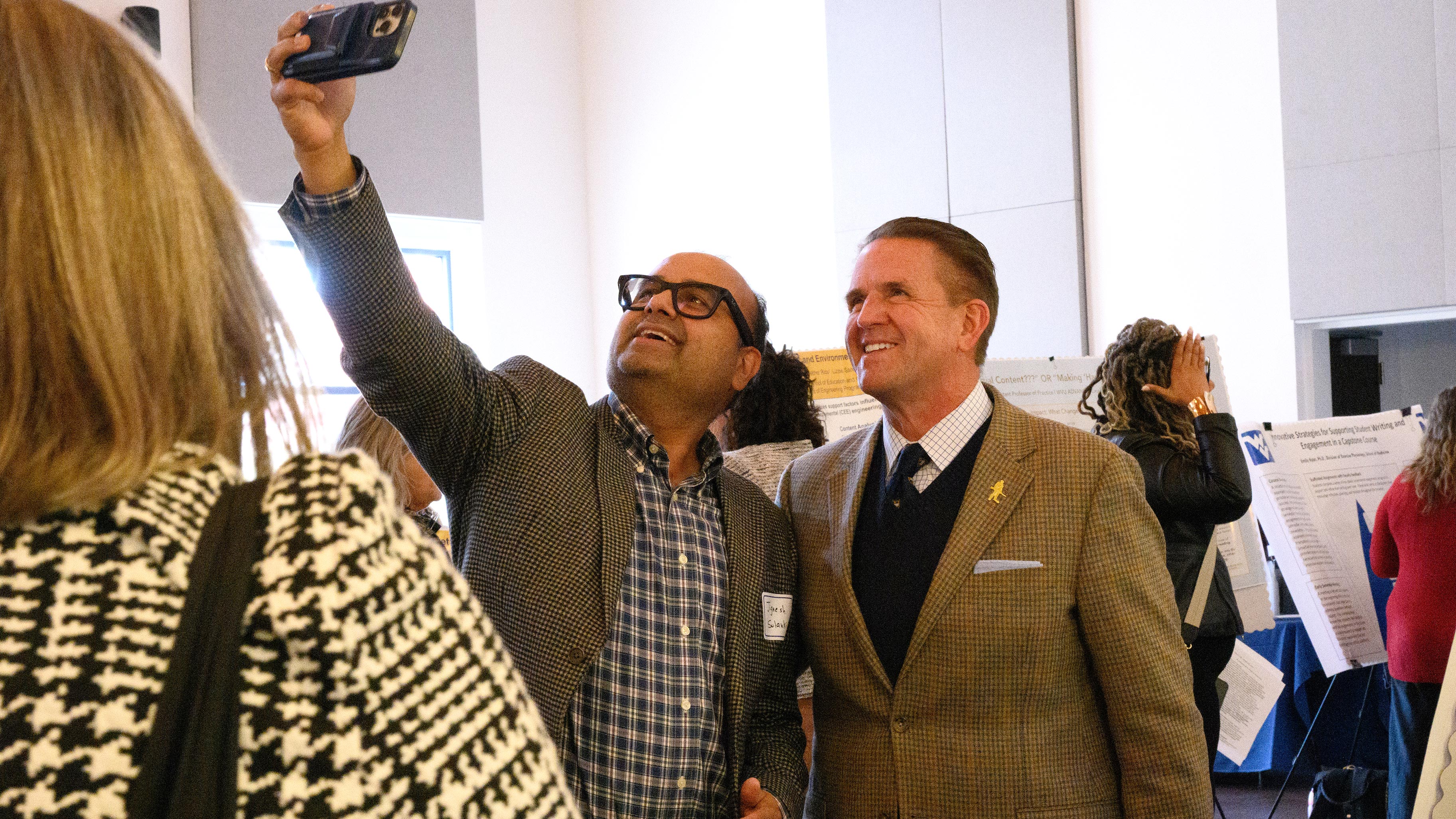 President Michael Benson enjoyed selfie with associate research professor Jignesh Solanki at the Teaching Faculty Symposium. (WVU Photo/Megan Rinker)