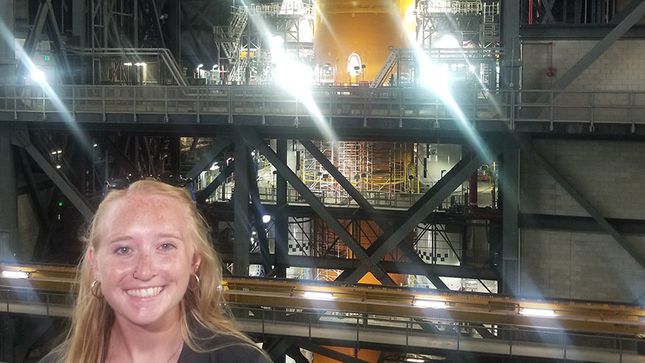 Kearney in front of a rocket at NASA