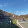 A rocky hillside along a highway. 