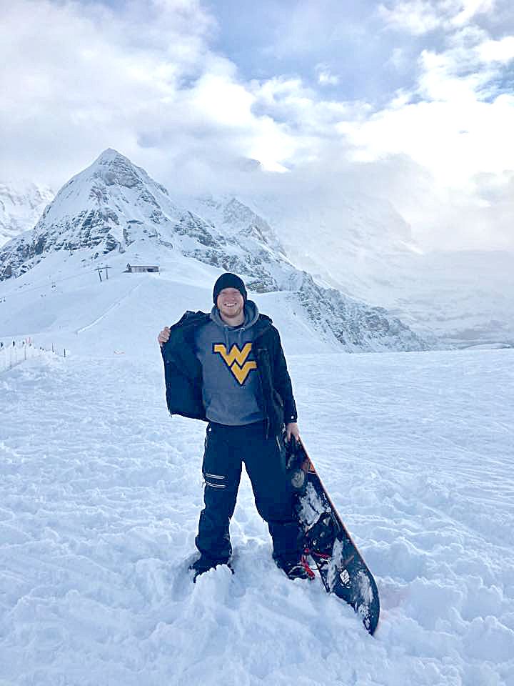 A photo of Tyler Hartman atop Switzerland’s Jungfrau Mountain.