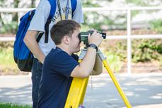 Max Kemp-Rye learning about land surveying at the Engineering in Service Camp 2017 
