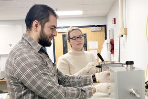 Graduate students in Song’s research lab perform a measurement of electrical properties