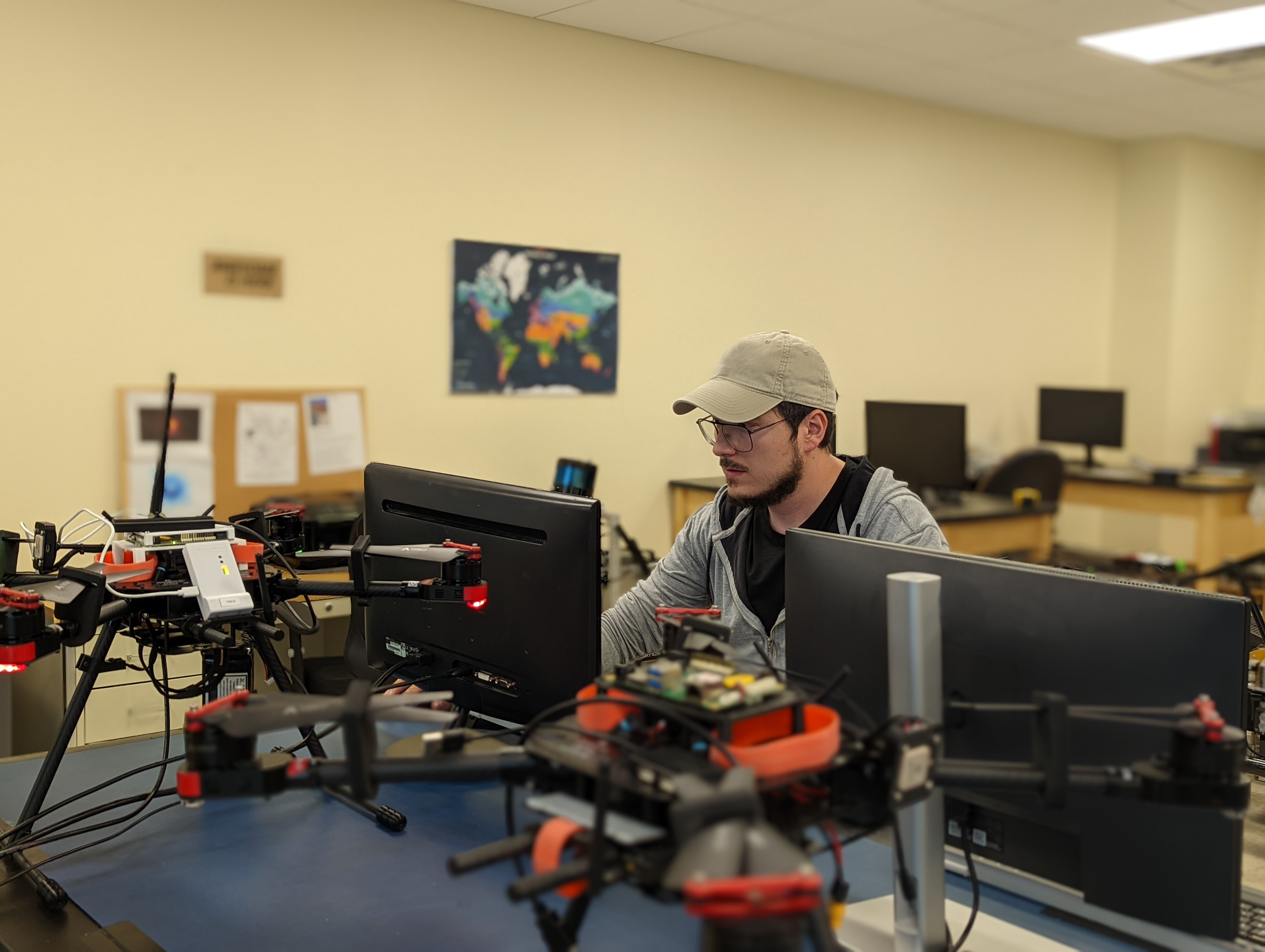 Student working with computer and drone.