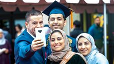 A family taking a selfie after the graduation ceremony.