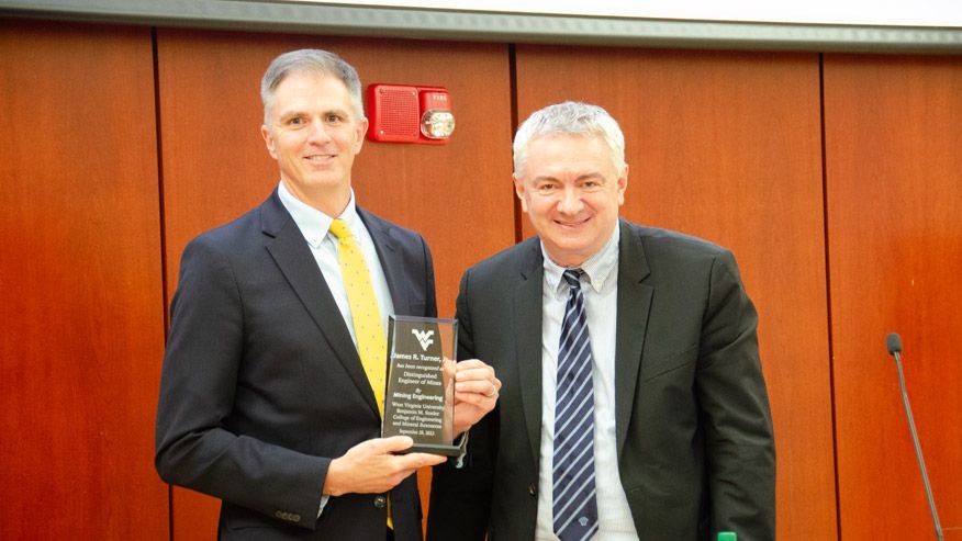 Vladislav Kecojevic presents James Turner with award at the 2023 annual Poundstone lecture